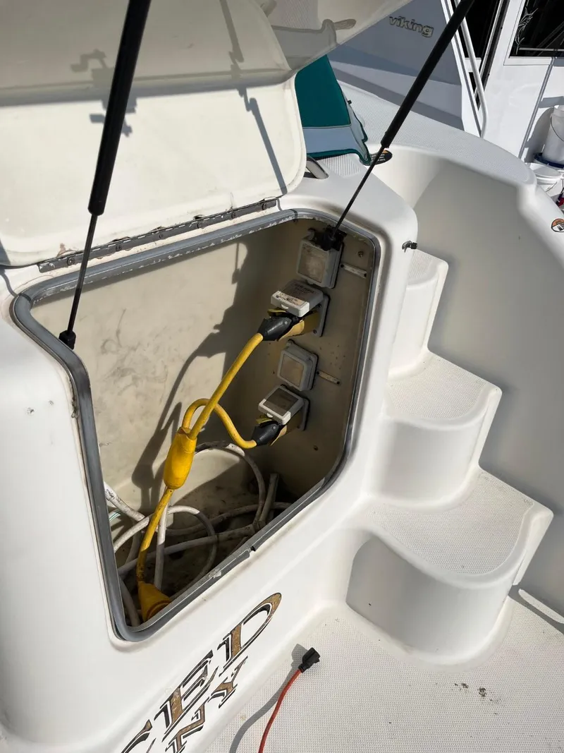 Slide: The Image of 1996 Maxum 4100 SCR boat electrical compartment with cables and outlets. - 7