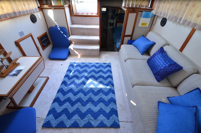 Slide: The Image of Interior of 1988 Carver 3207 yacht with blue decor and chevron rug. - 16