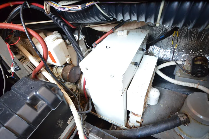 Slide: The Image of Engine compartment of a 1988 Carver 3207 boat, showing wiring and mechanical components. - 22