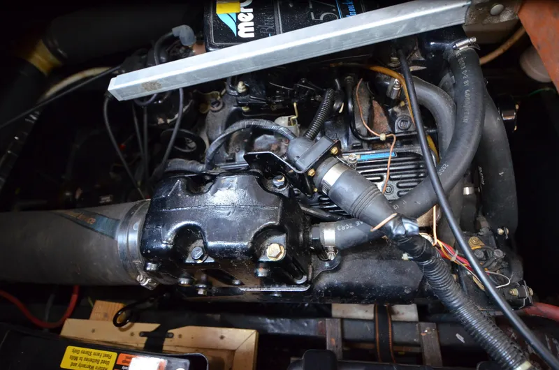 Slide: The Image of Engine of a 1988 Carver 3207 boat, featuring various hoses and components. - 23