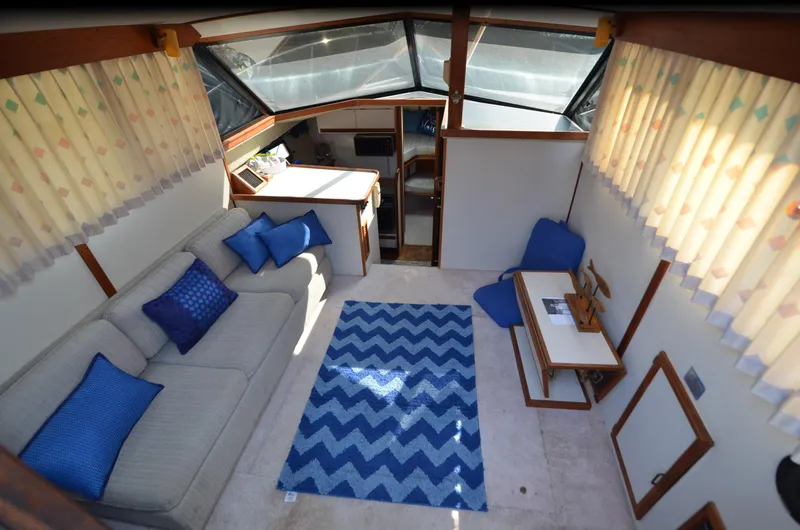 Slide: The Image of Interior of 1988 Carver 3207 yacht with cozy seating and nautical decor. - 8