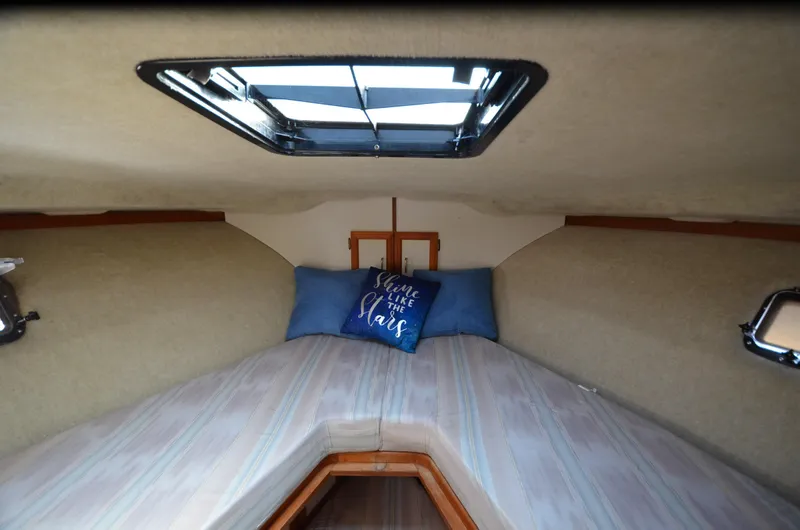 Slide: The Image of Cozy cabin interior of 1988 Carver 3207 boat with skylight and decorative pillow. - 9