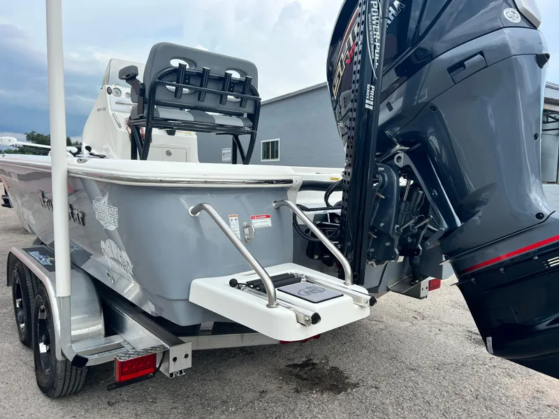 Slide: The Image of 2023 NauticStar 227 XTS boat on trailer with powerful outboard motor. - 13