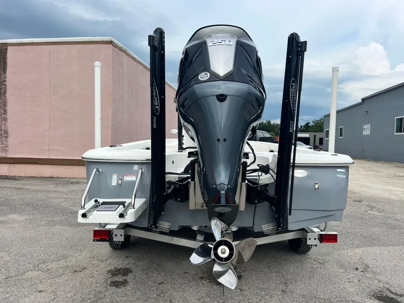 Slide: The Image of 2023 NauticStar 227 XTS boat with powerful outboard motor, parked on a trailer. - 7