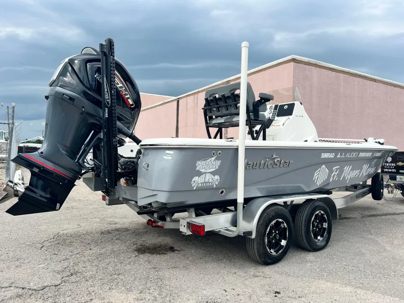 Slide: The Image of 2023 NauticStar 227 XTS boat on trailer with powerful outboard motor. - 8