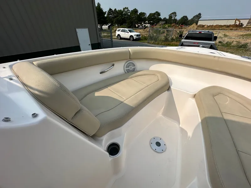 Slide: The Image of 2016 Pursuit DC 265 Dual Console boat with beige seating and cup holder. - 13
