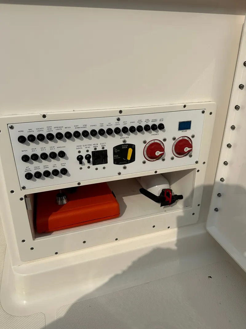Slide: The Image of Control panel of a 2016 Pursuit DC 265 Dual Console boat, featuring switches and gauges. - 18