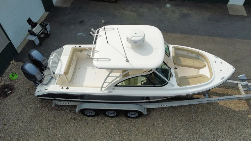 Slide: The Image of 2016 Pursuit DC 265 Dual Console boat on trailer, aerial view. - 4