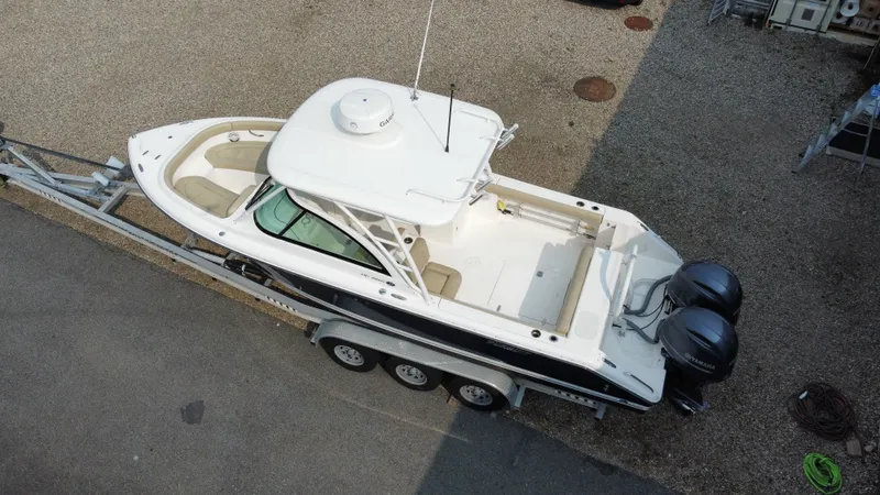 Slide: The Image of 2016 Pursuit DC 265 Dual Console boat on trailer, aerial view. - 5