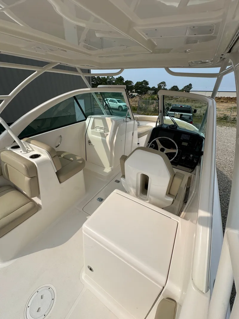 Slide: The Image of 2016 Pursuit DC 265 Dual Console boat interior with seating and helm. - 8