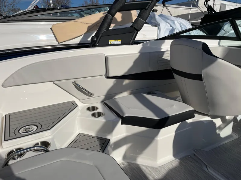 Slide: The Image of 2023 Sea Ray SPX 210 boat interior with seating and cup holders. - 3