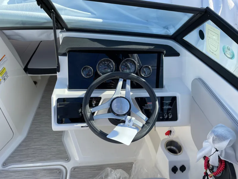Slide: The Image of 2023 Sea Ray SPX 210 boat dashboard with steering wheel and gauges. - 4