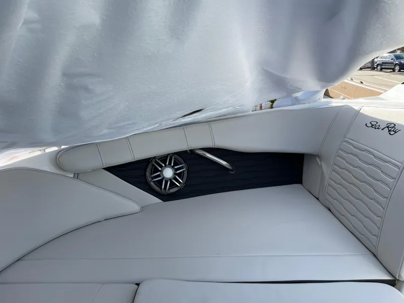 Slide: The Image of 2023 Sea Ray SPX 210 boat interior with white leather seating and speaker detail. - 5