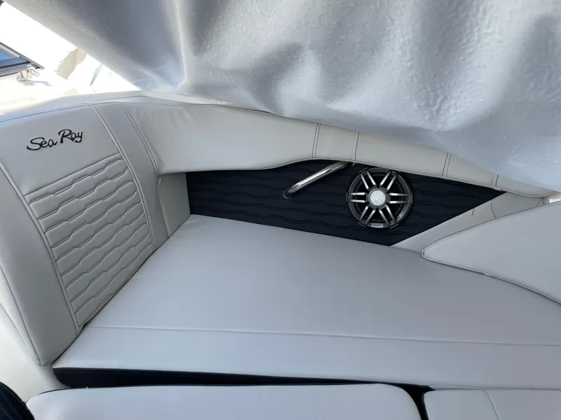 Slide: The Image of 2023 Sea Ray SPX 210 boat interior with white seating and speaker detail. - 6
