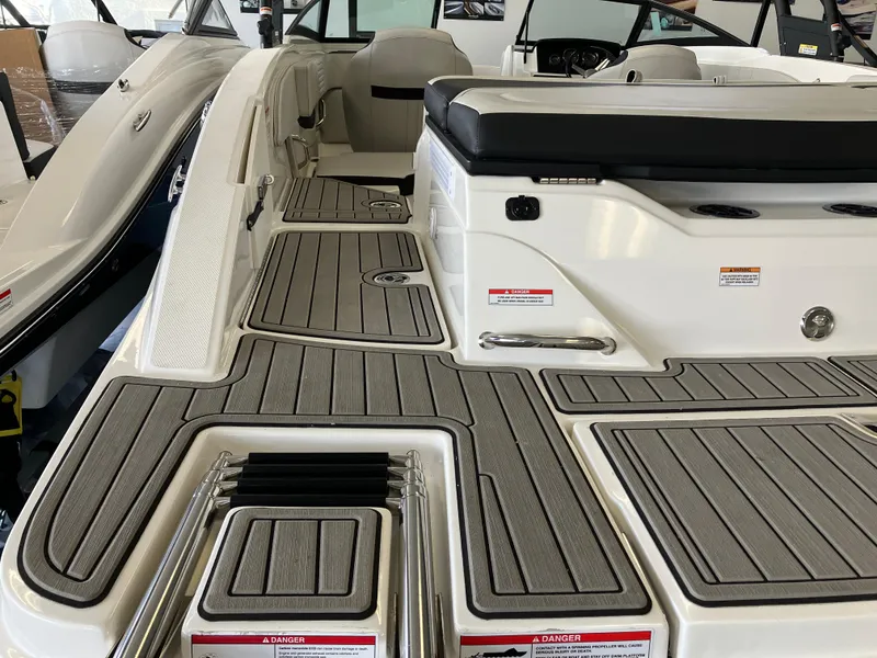 Slide: The Image of 2023 Sea Ray SPX 210 boat interior with sleek seating and modern deck design. - 7