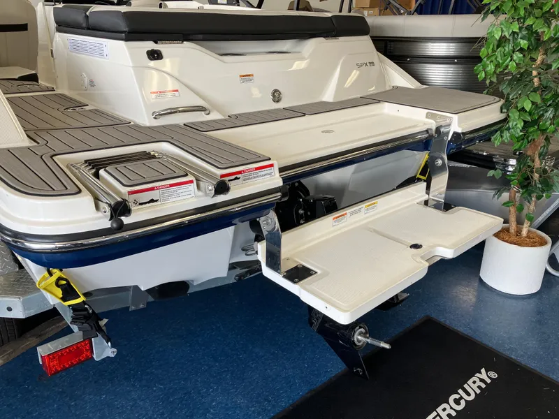 Slide: The Image of 2023 Sea Ray SPX 210 boat with extended swim platform in showroom. - 8