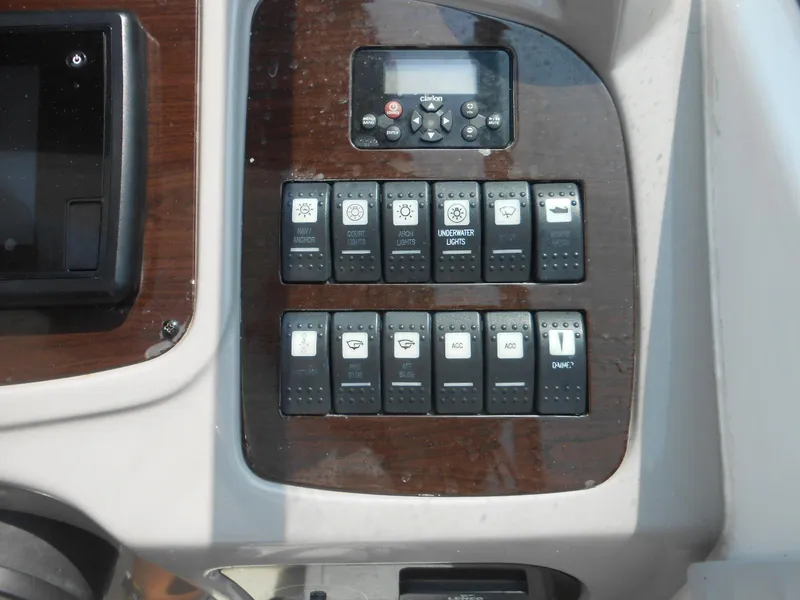 Slide: The Image of Control panel of a 2014 Chaparral 270 Signature boat with various switches and buttons. - 10