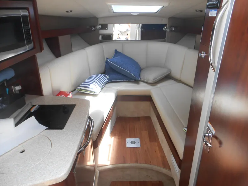 Slide: The Image of 2014 Chaparral 270 Signature cabin interior with cozy seating and modern amenities. - 19