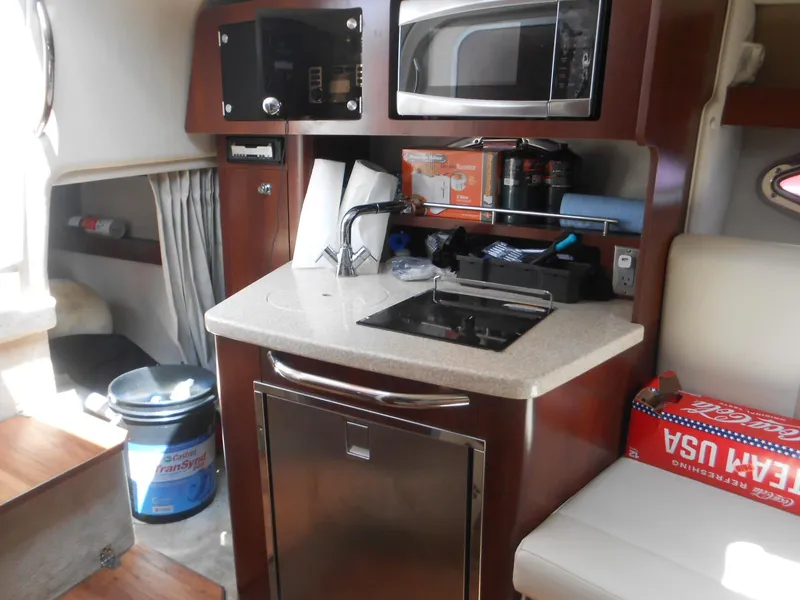Slide: The Image of Compact kitchen area in 2014 Chaparral 270 Signature boat with microwave and sink. - 20