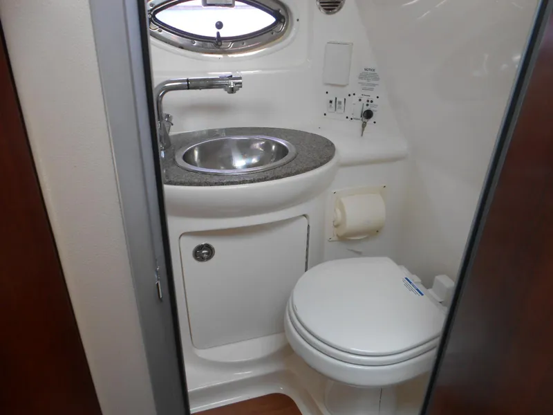 Slide: The Image of 2014 Chaparral 270 Signature boat bathroom with sink and toilet. - 21
