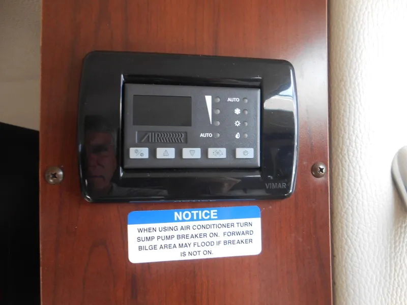 Slide: The Image of Control panel on 2014 Chaparral 270 Signature with air conditioner notice. - 22