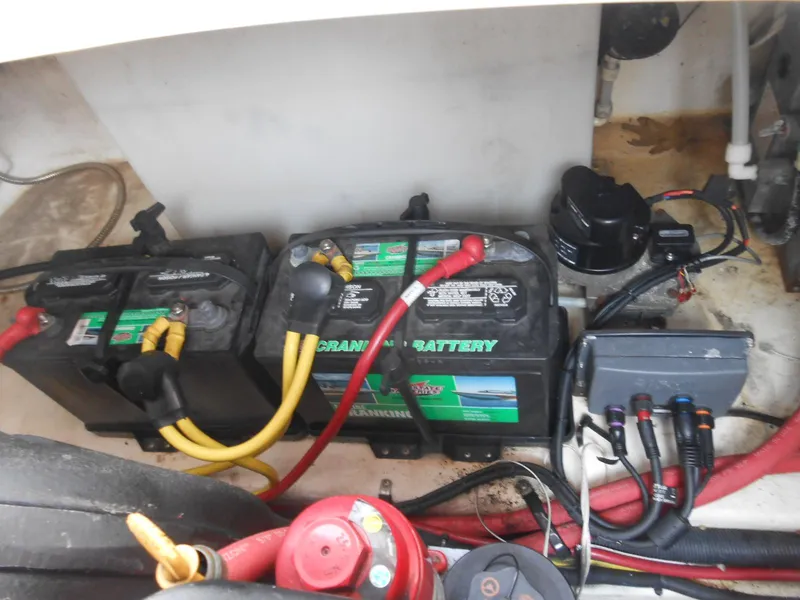 Slide: The Image of Batteries and wiring in a 2014 Chaparral 270 Signature boat engine compartment. - 26