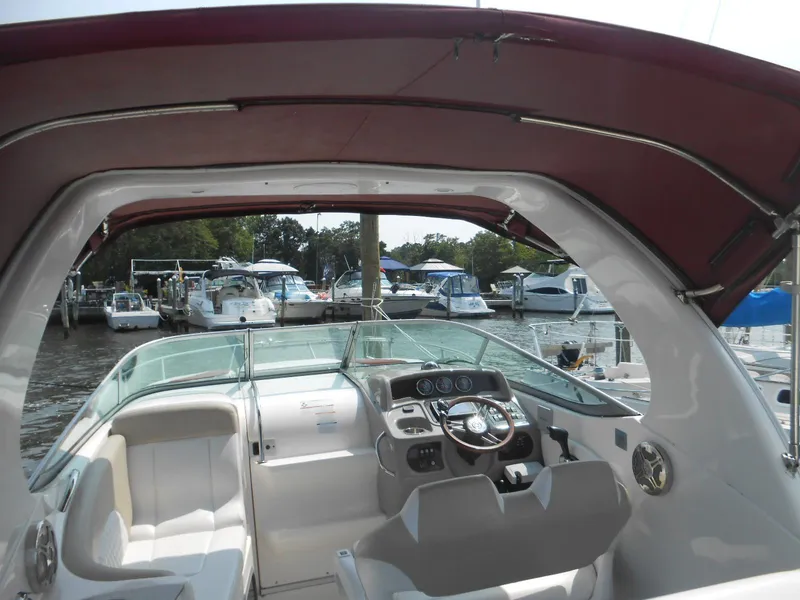 Slide: The Image of 2014 Chaparral 270 Signature boat interior with steering wheel and seating at marina. - 5