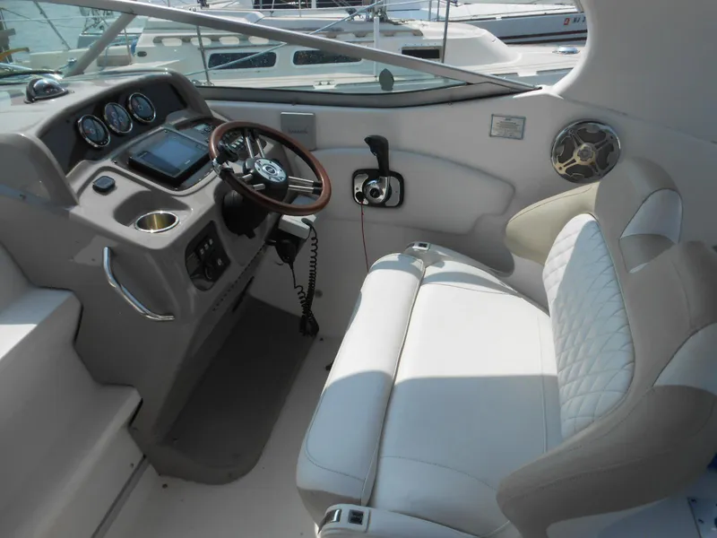 Slide: The Image of 2014 Chaparral 270 Signature boat interior with steering wheel and white seating. - 6