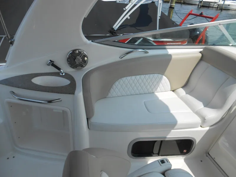 Slide: The Image of 2014 Chaparral 270 Signature boat interior with cushioned seating and sleek design. - 7