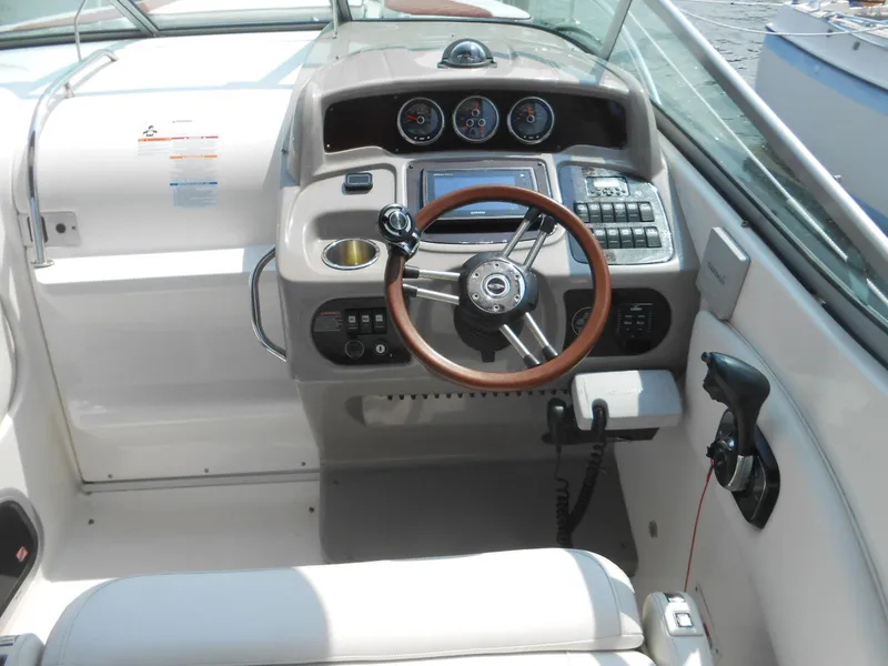 Slide: The Image of 2014 Chaparral 270 Signature boat cockpit with steering wheel and control panel. - 9