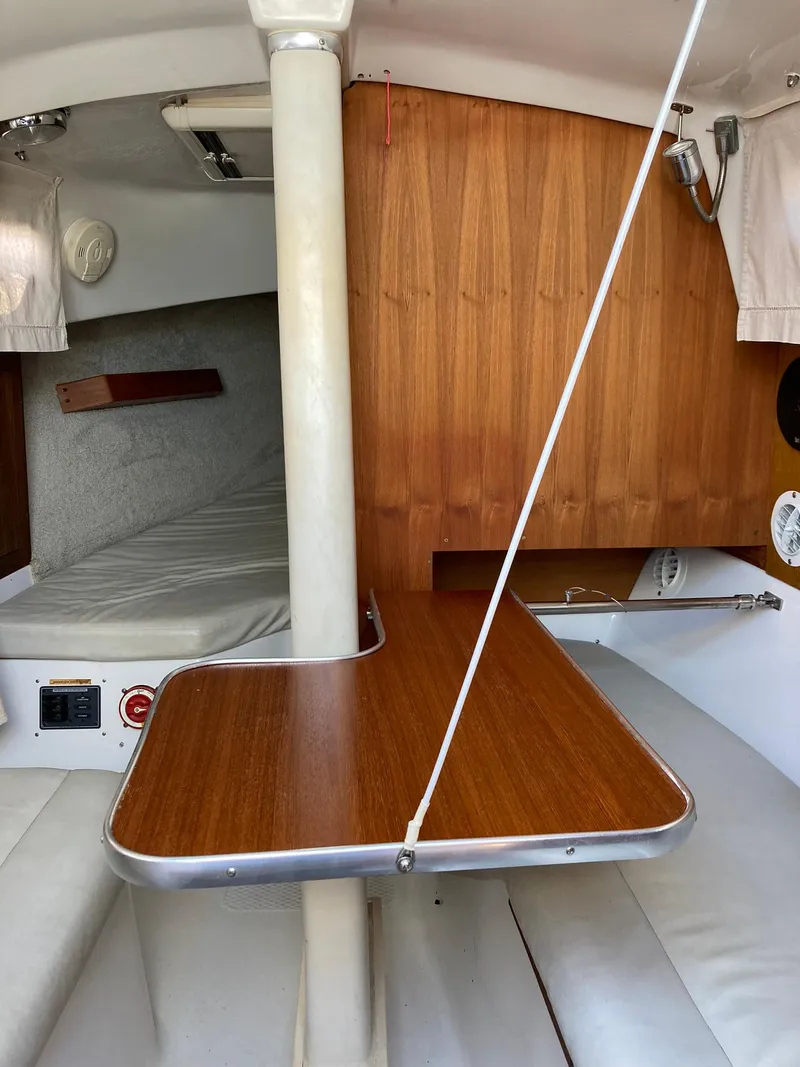 Slide: The Image of 2006 Hake Seaward 26RK cabin interior with wood accents and seating area. - 4