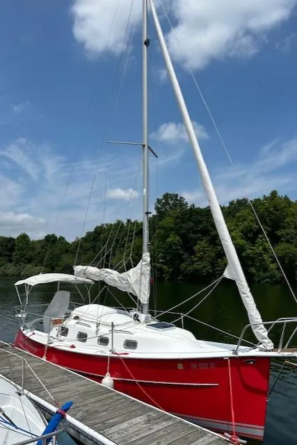 Slide: The Image of Red 2006 Hake Seaward 26RK sailboat docked on a sunny day. - 7