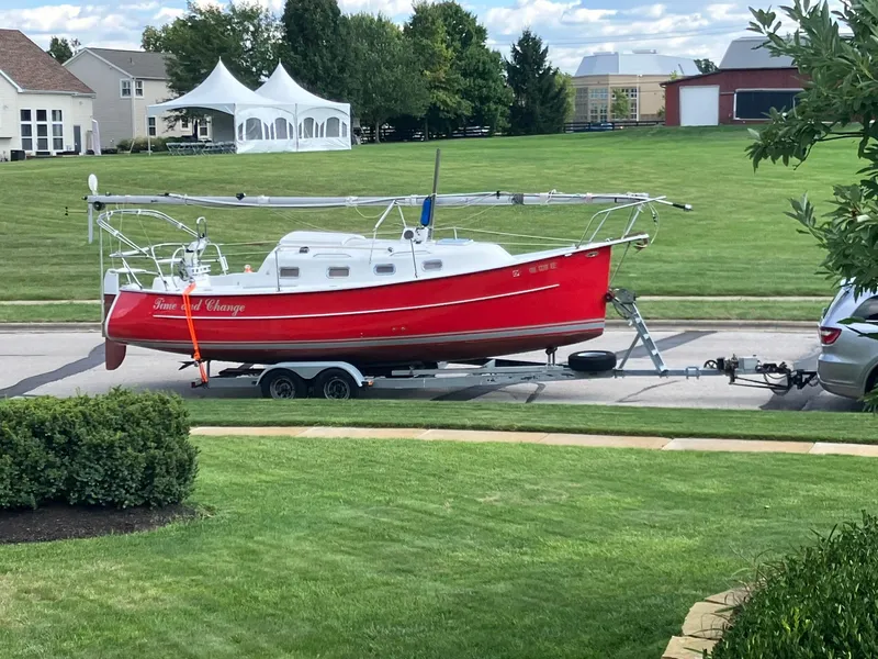Slide: The Image of Red 2006 Hake Seaward 26RK sailboat on trailer in suburban neighborhood. - 9