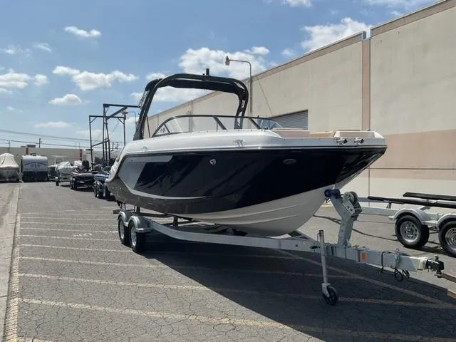 Slide: The Image of 2025 Bayliner D22I boat on trailer in parking lot, sunny day. - 2