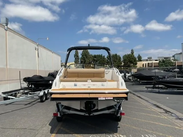 Slide: The Image of 2025 Bayliner D22I boat parked outdoors under a clear blue sky. - 4