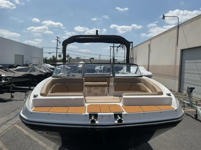 Slide: The Image of 2025 Bayliner D22I boat with sleek design, docked outdoors under a clear sky. - 6