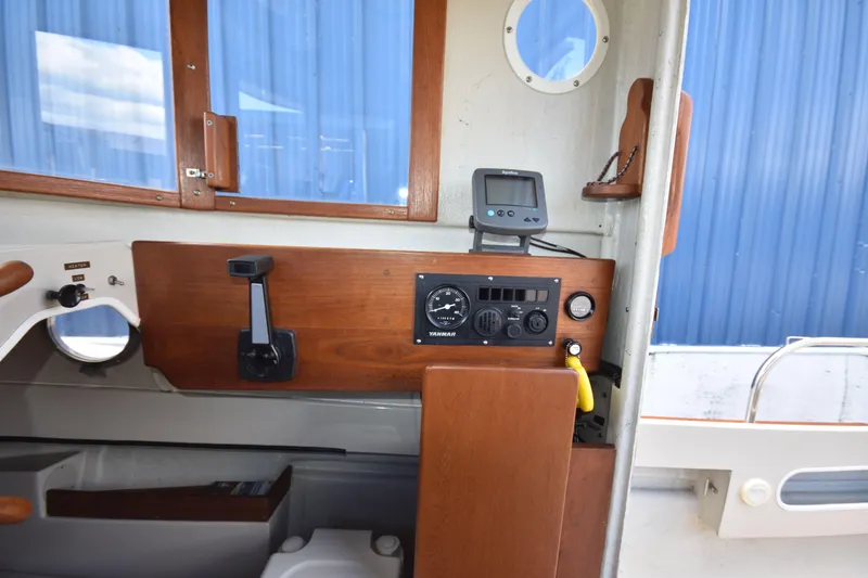 Slide: The Image of Interior of 1994 Ranger Tugs R21 boat with control panel and wooden accents. - 20