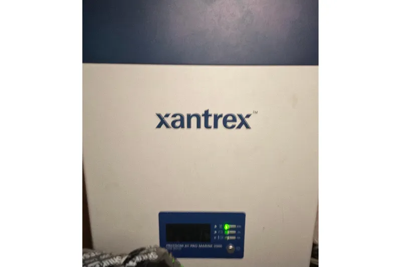 Slide: The Image of Xantrex inverter on a 2001 Island Packet 420 sailboat, displaying control panel and indicators. - 37