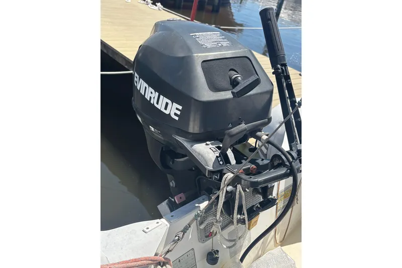 Slide: The Image of Evinrude outboard motor on a 2001 Island Packet 420 sailboat at dock. - 43