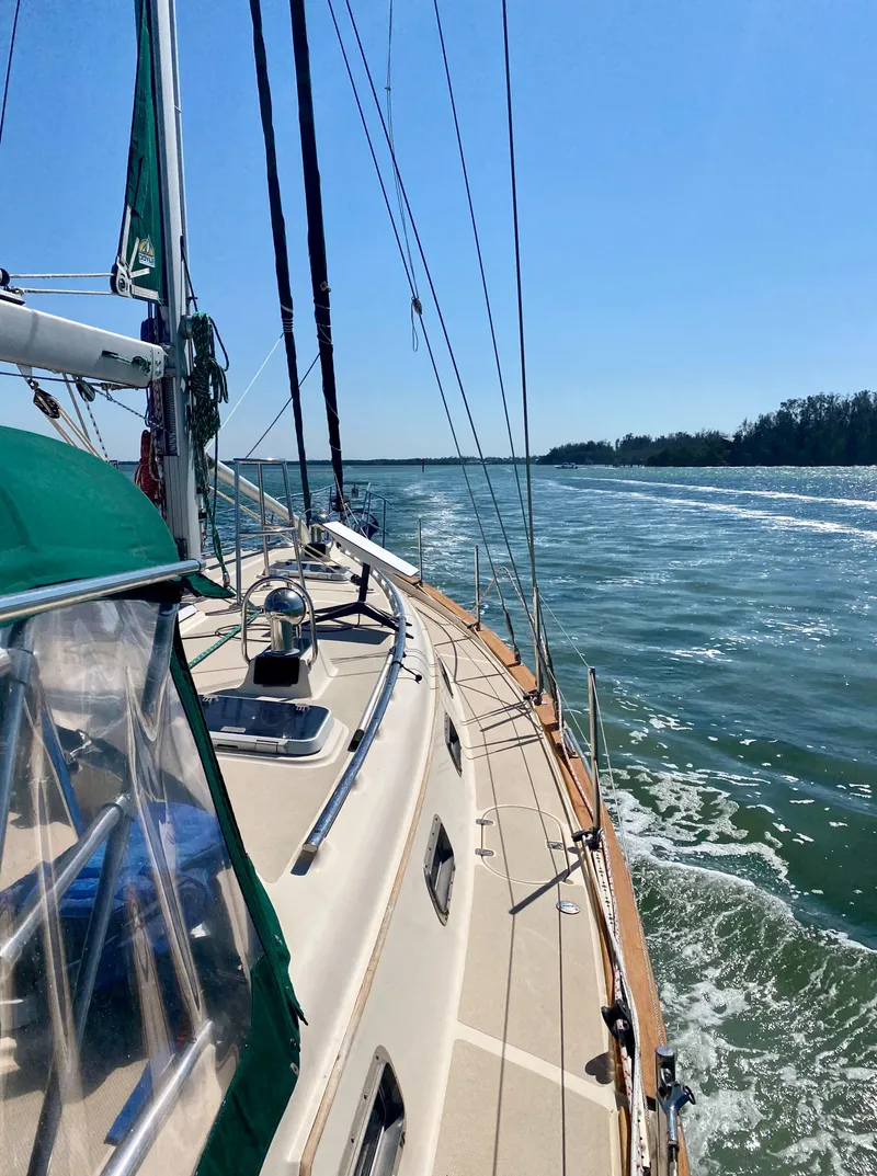 Slide: The Image of 2001 Island Packet 420 sailboat cruising on calm waters. - 8