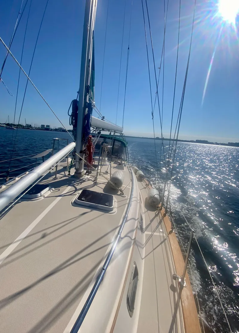 Slide: The Image of 2001 Island Packet 420 sailboat on sunny sea. - 9