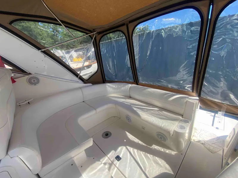 Slide: The Image of 2004 Cruisers Yachts 340 Express interior with white seating and enclosed canopy. - 10