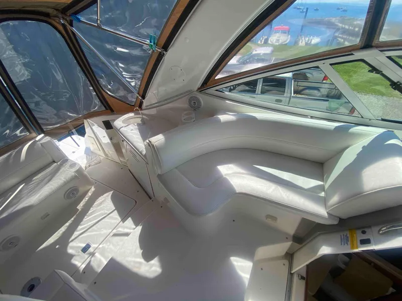 Slide: The Image of 2004 Cruisers Yachts 340 Express cockpit with white seating and navigation controls. - 13