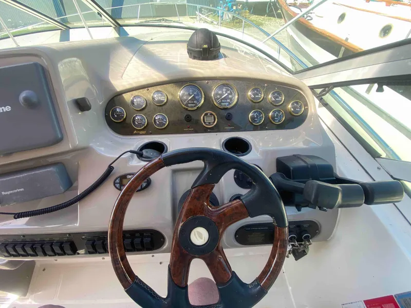 Slide: The Image of 2004 Cruisers Yachts 340 Express interior with white seating and panoramic windows. - 15