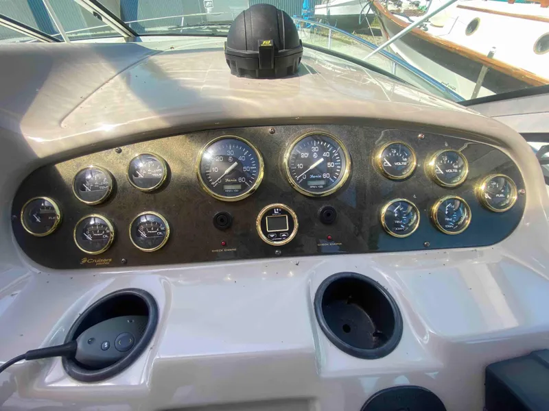 Slide: The Image of 2004 Cruisers Yachts 340 Express helm with gauges and steering wheel. - 16