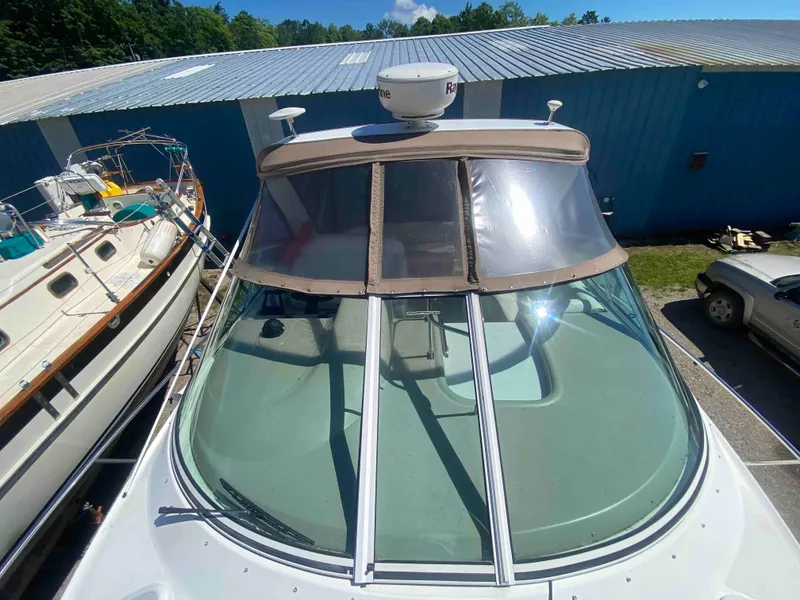 Slide: The Image of 2004 Cruisers Yachts 340 Express helm with dashboard and steering wheel. - 27