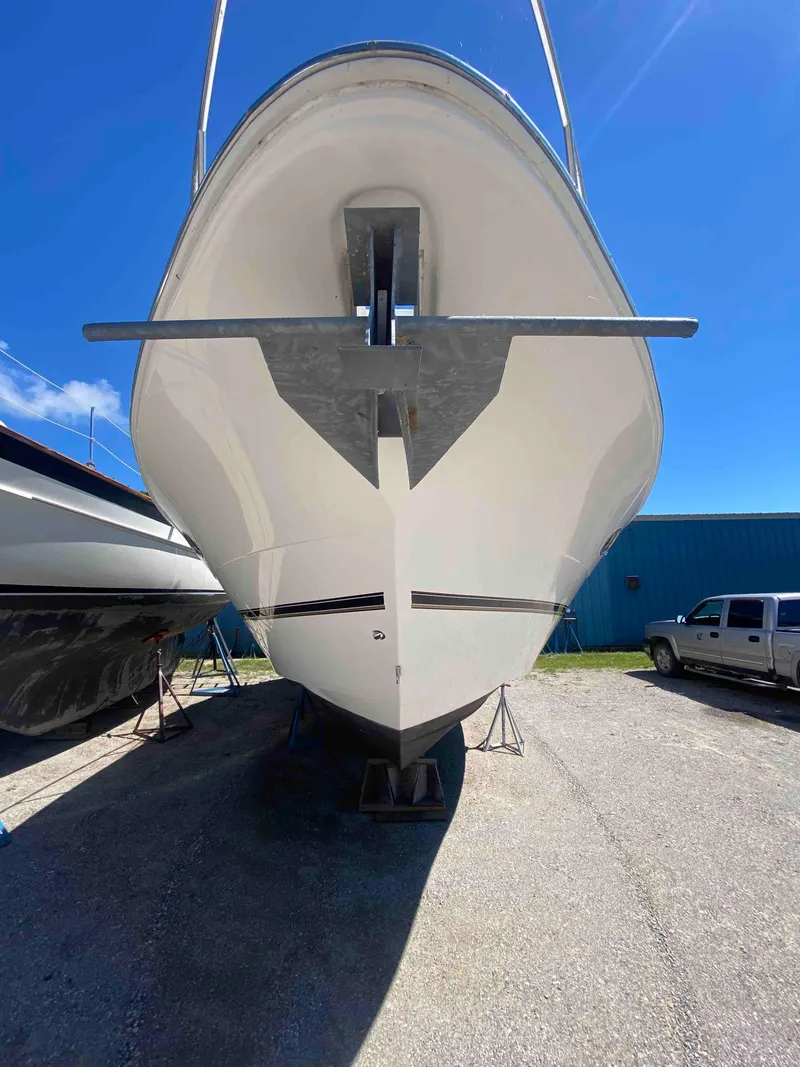 Slide: The Image of 2004 Cruisers Yachts 340 Express, docked, with clear blue sky background. - 29