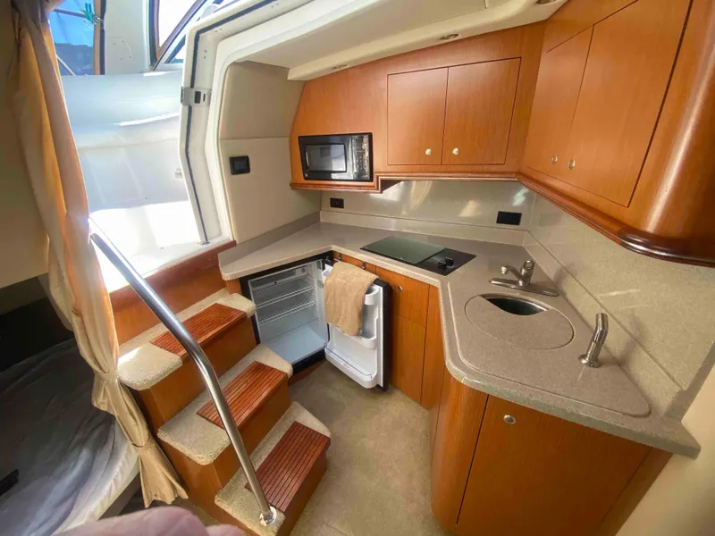 Slide: The Image of 2004 Cruisers Yachts 340 Express boat on dry dock, viewed from the front. - 30