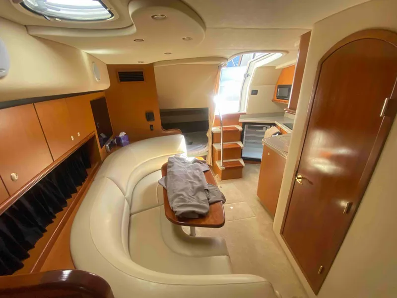 Slide: The Image of 2004 Cruisers Yachts 340 Express interior kitchen with wood cabinets and modern appliances. - 31