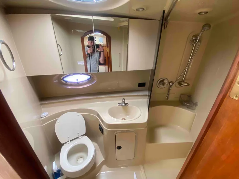 Slide: The Image of 2004 Cruisers Yachts 340 Express interior with wooden cabinetry and stairs. - 37
